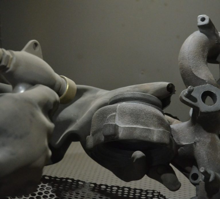 an engine part being dry blasted an engine part being dry blasted